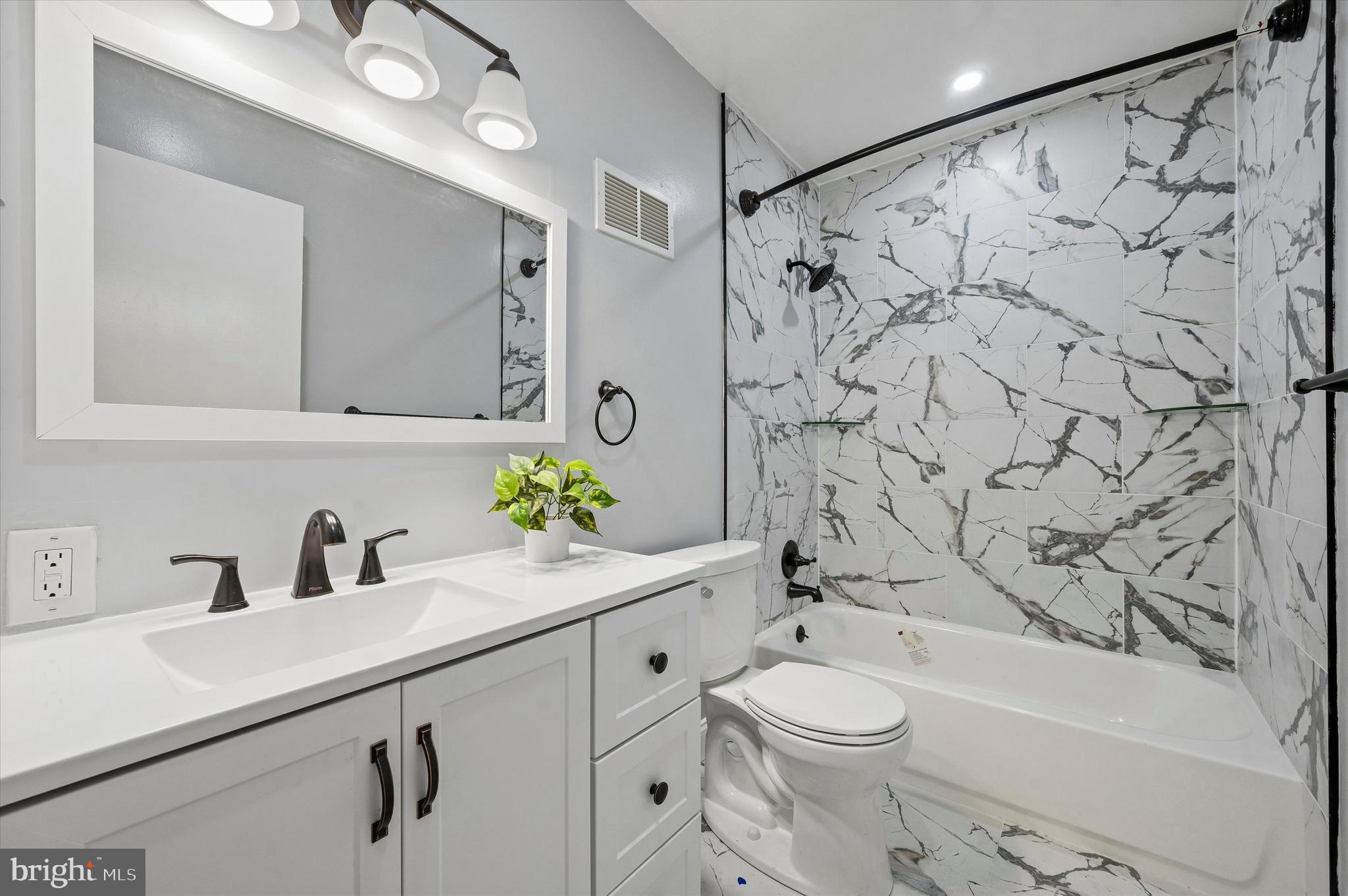 6129 Spruce Street Philadelphia, PA 19139 - Photo 10 of 18 a bathroom with a sink a toilet and shower