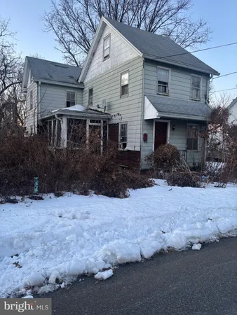 a front view of house with yard and trees around