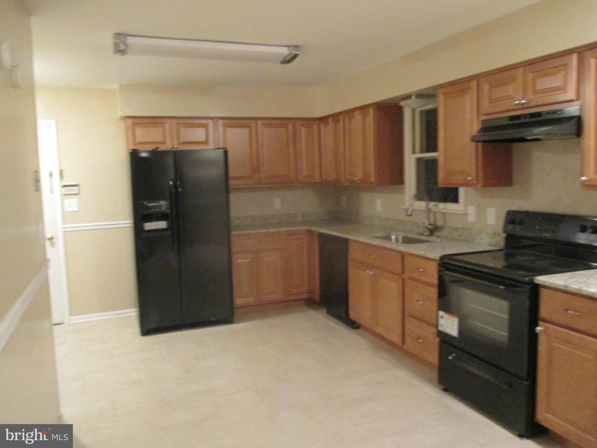 19706 Trunk Road White Hall, MD 21161 - Photo 7 of 19 a kitchen with stainless steel appliances granite countertop a refrigerator and a sink
