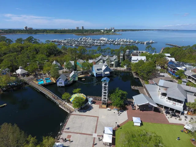 a view of a patio with table and chairs potted plants with wooden floor and fence