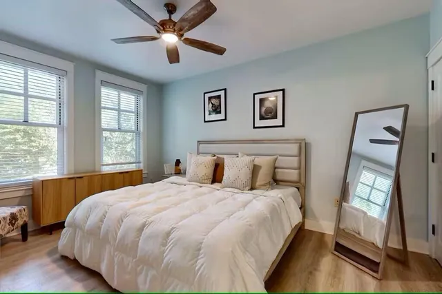 a bedroom with a bed and a large window