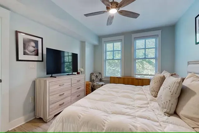 a bedroom with a large bed and a flat screen tv