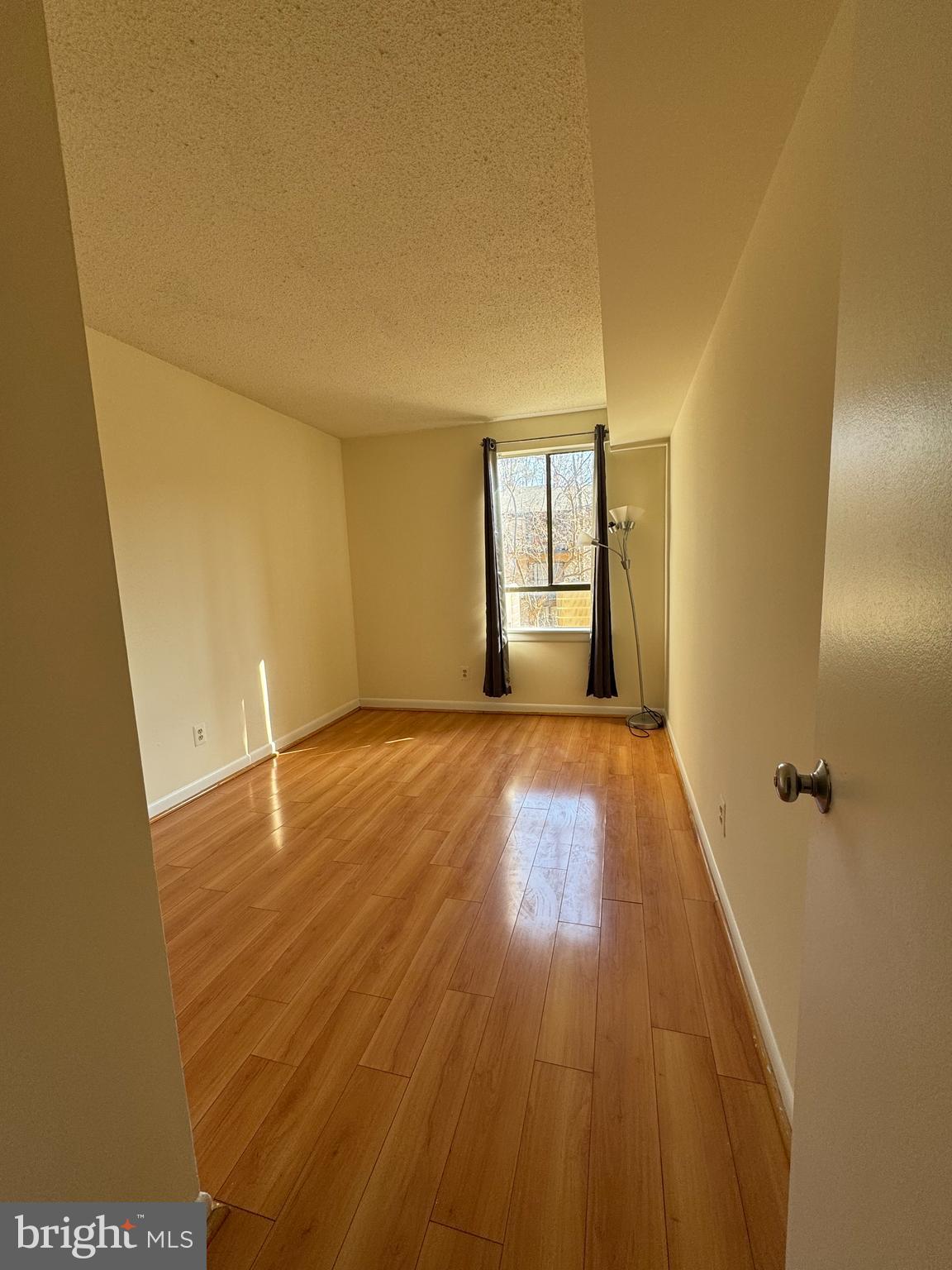 2247 Castle Rock Square, Unit 1B Reston, VA 20191 - Photo 13 of 26 wooden floor in an empty room with a window