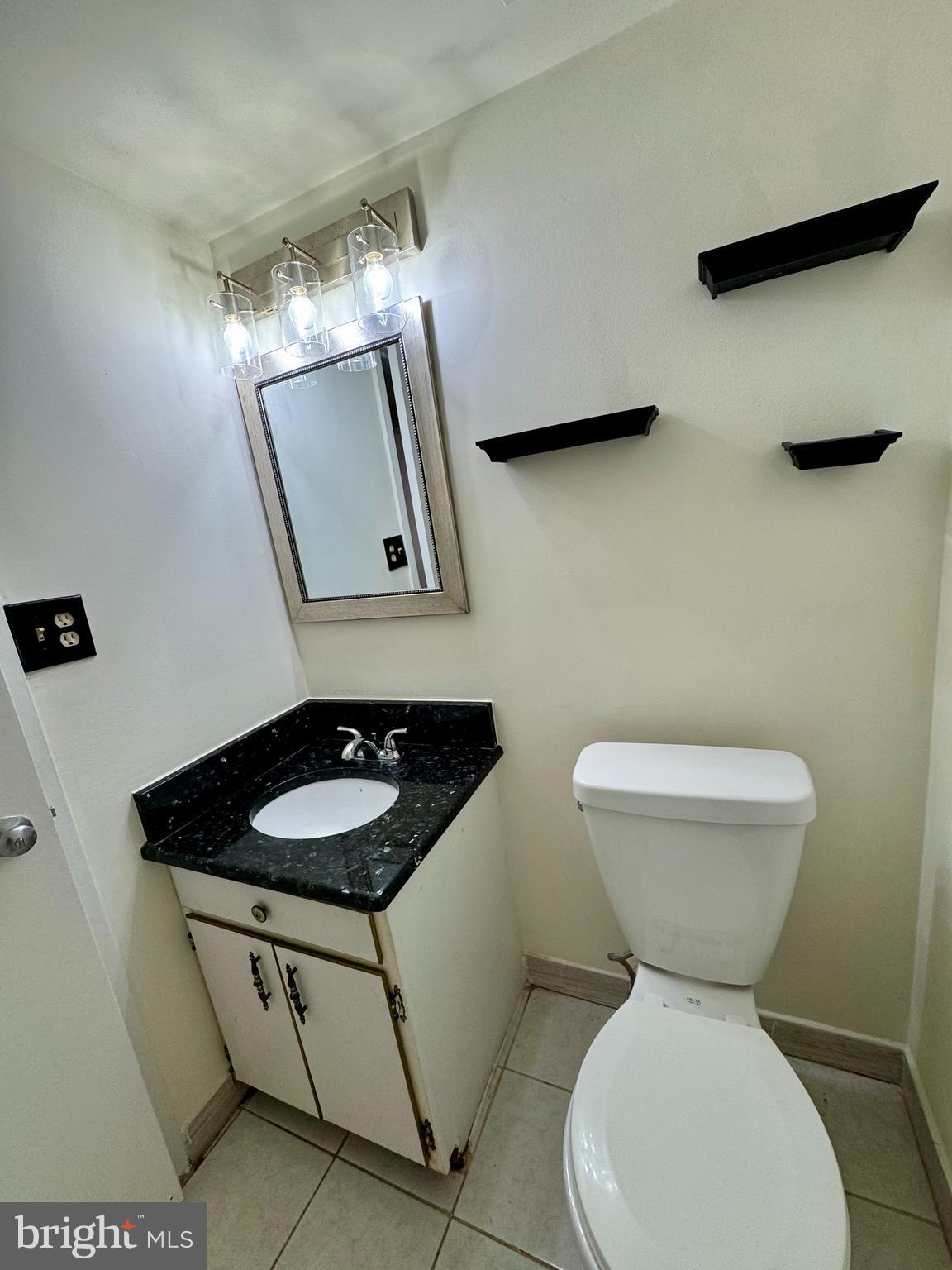 2247 Castle Rock Square, Unit 1B Reston, VA 20191 - Photo 18 of 26 a bathroom with a toilet a sink and mirror