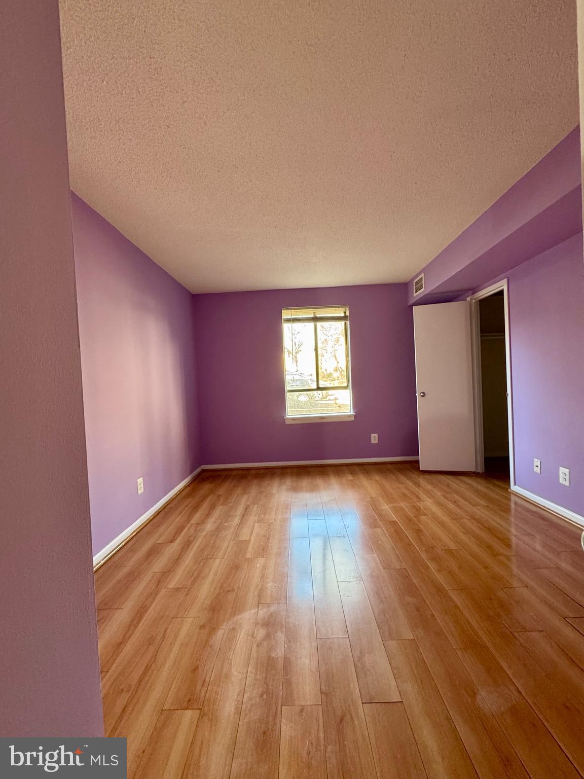 2247 Castle Rock Square, Unit 1B Reston, VA 20191 - Photo 19 of 26 a view of an empty room and window and wooden floor