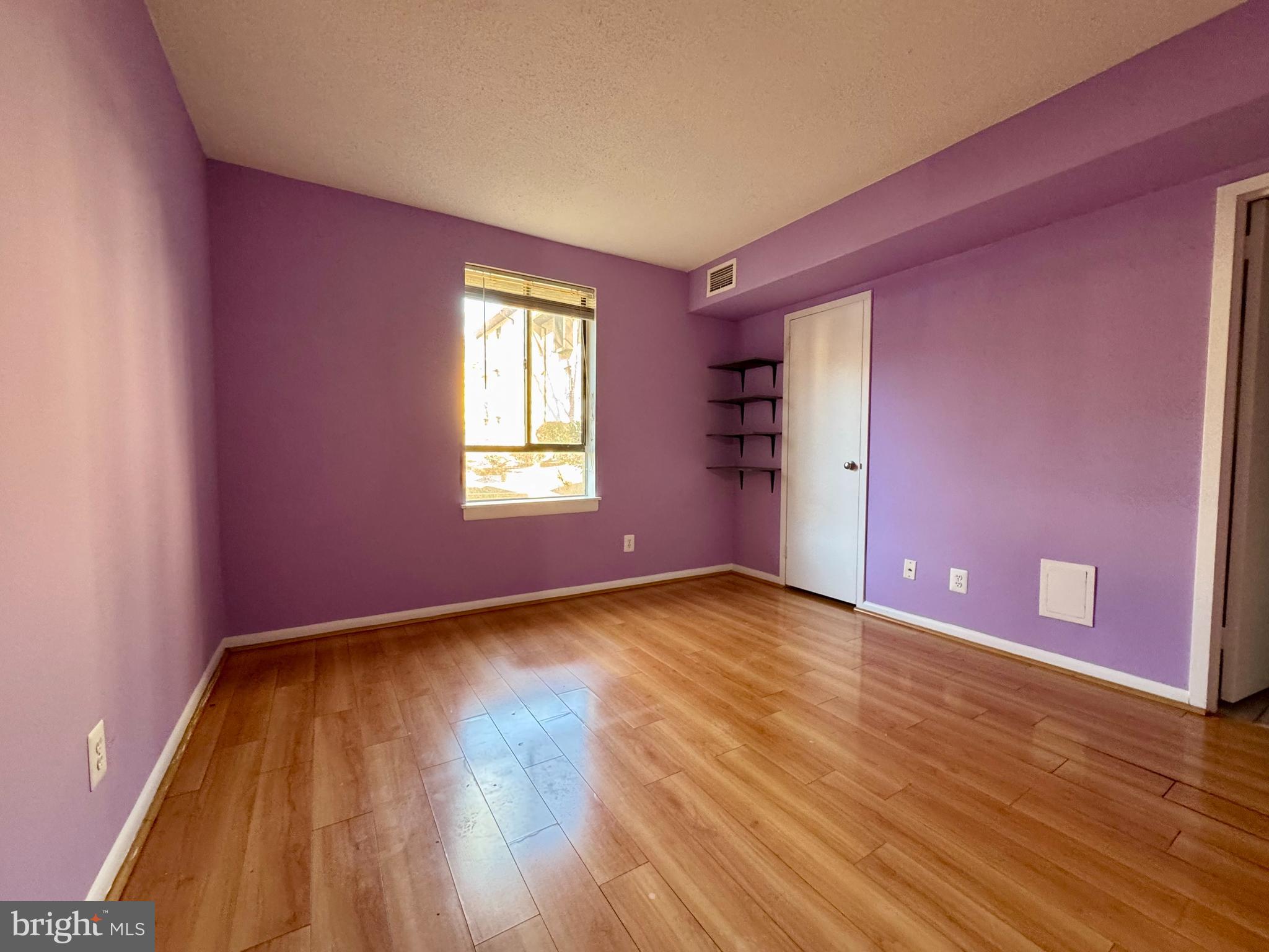 2247 Castle Rock Square, Unit 1B Reston, VA 20191 - Photo 20 of 26 a view of empty room with wooden floor and fan