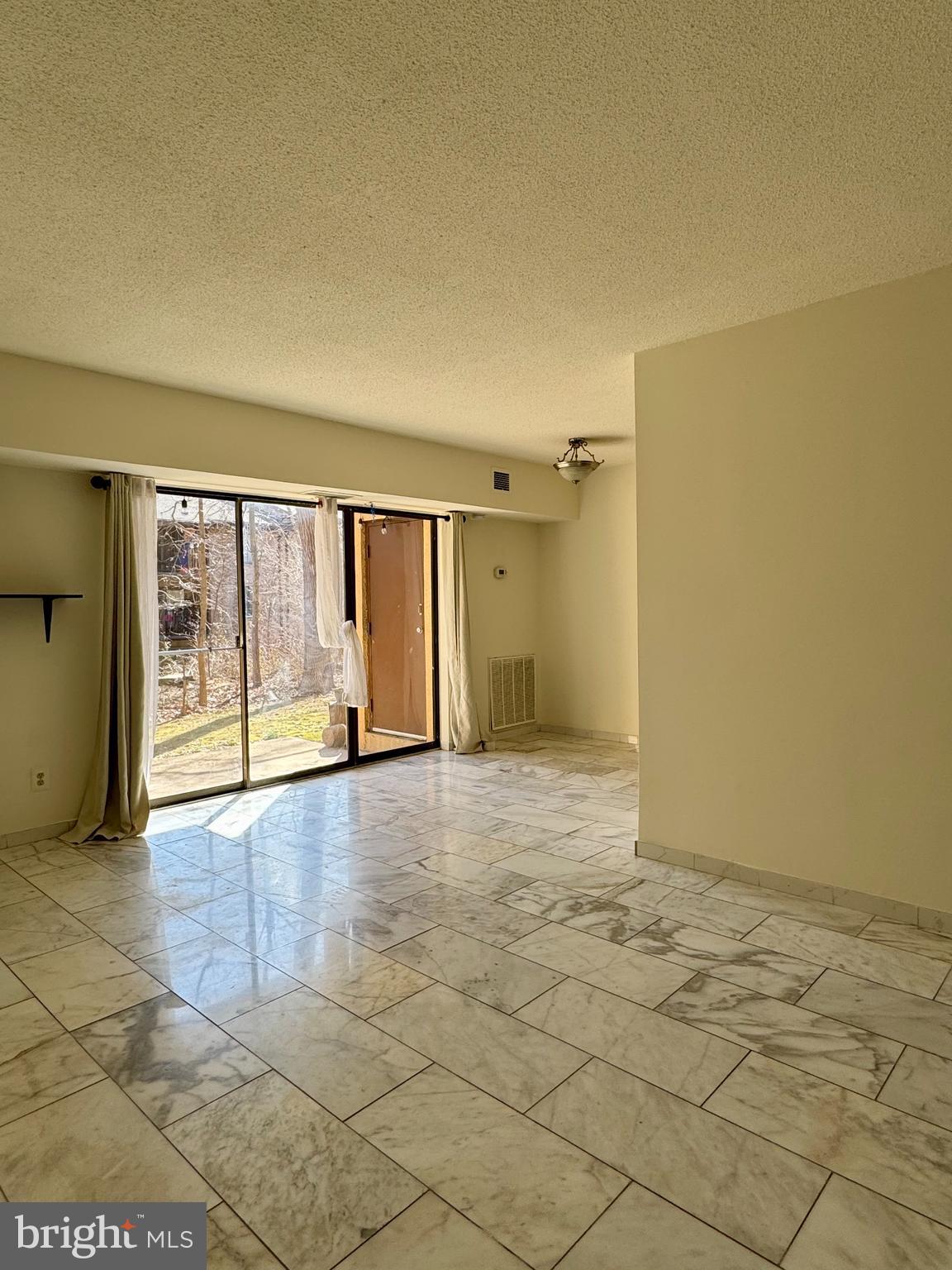 2247 Castle Rock Square, Unit 1B Reston, VA 20191 - Photo 5 of 26 a view of an empty room and window