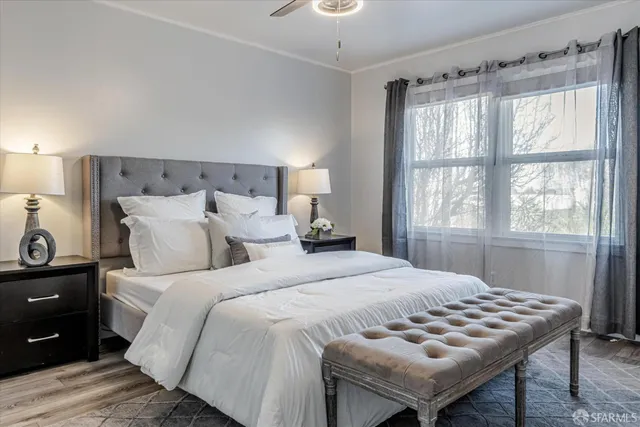 a bedroom with a bed and a window