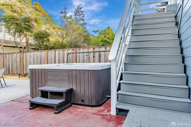 a balcony with a potted plant and outdoor seating