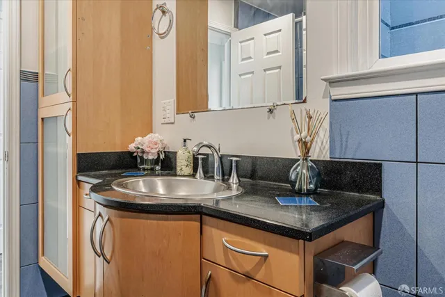 a kitchen with sink a microwave and cabinets