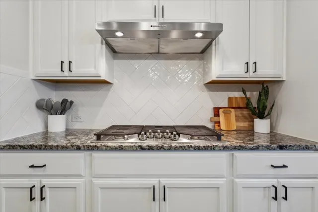 a kitchen with a stove and cabinets