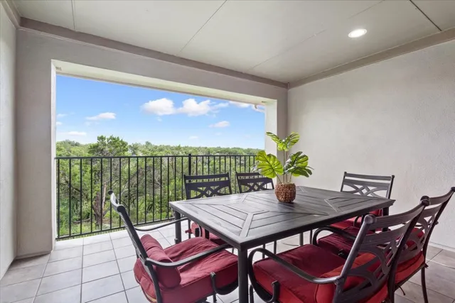 a view of a yard with plants and a bench