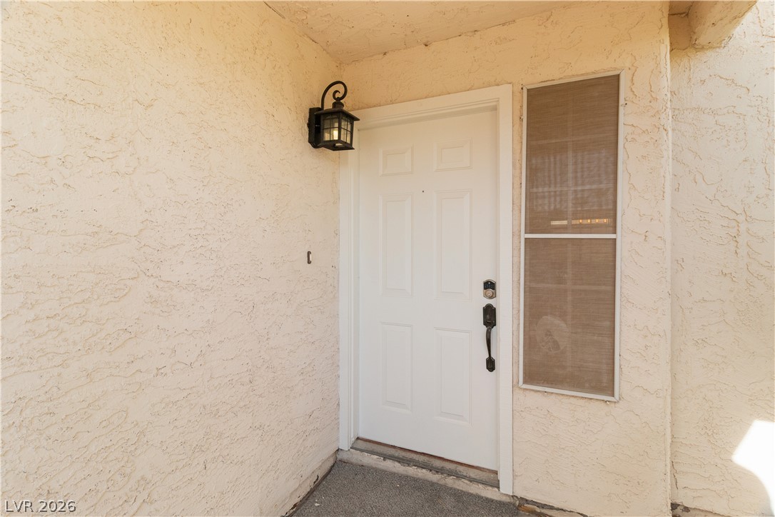 3156 Terrace View Drive Laughlin, NV 89029 - Photo 5 of 94 Welcome home through a bright white entry door with a classic lantern fixture.
