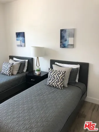 a bedroom with a bed and a couch