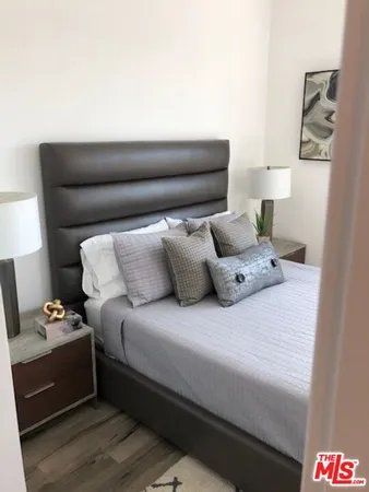 a bedroom with a bed and a couch