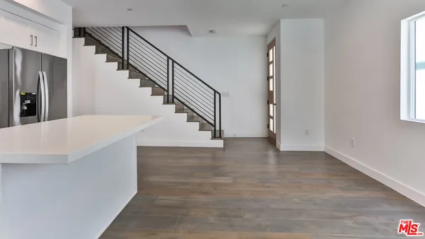 a view of entryway and hall with wooden floor