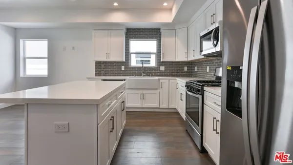 a kitchen with a sink stove and refrigerator