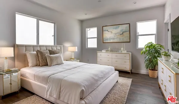 a bedroom with a bed and a large window