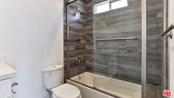 a bathroom with a toilet and a shower