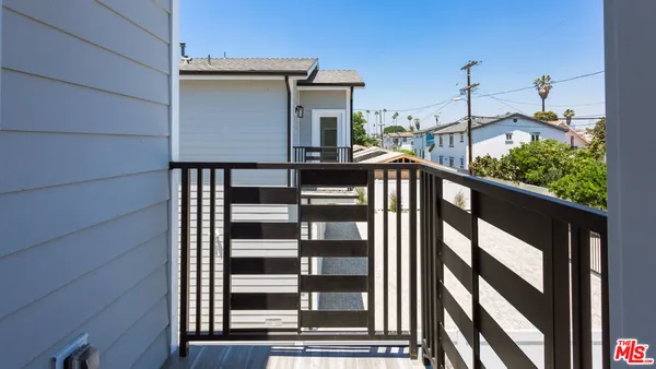 a view of a balcony with wooden floor and fence