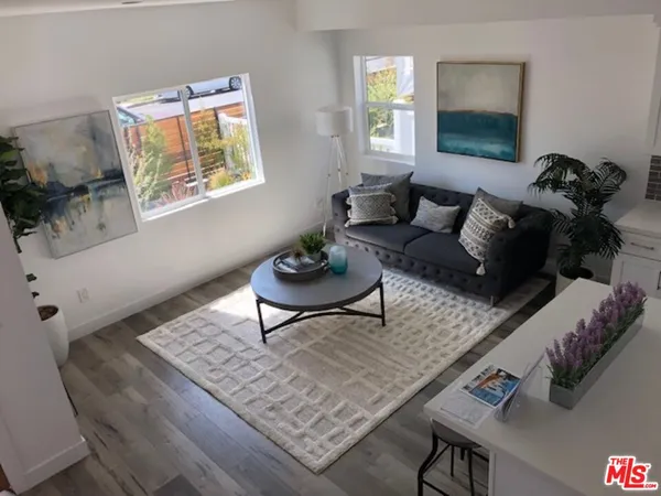 a living room with furniture and a potted plant
