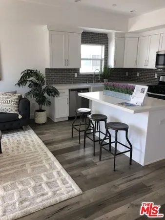 a kitchen with a table and chairs in it