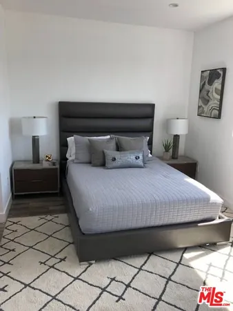 a bedroom with a bed and a lamp