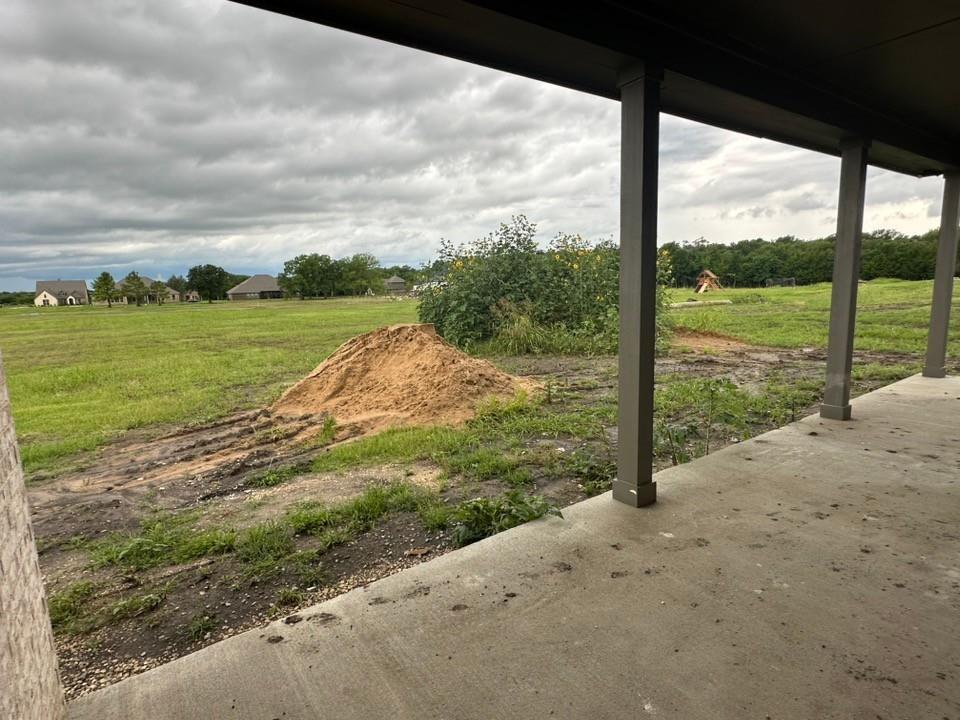 585 Brown Road Leonard, TX 75452 - Photo 26 of 29 Concrete patio with structural columns overlooking expansive green space