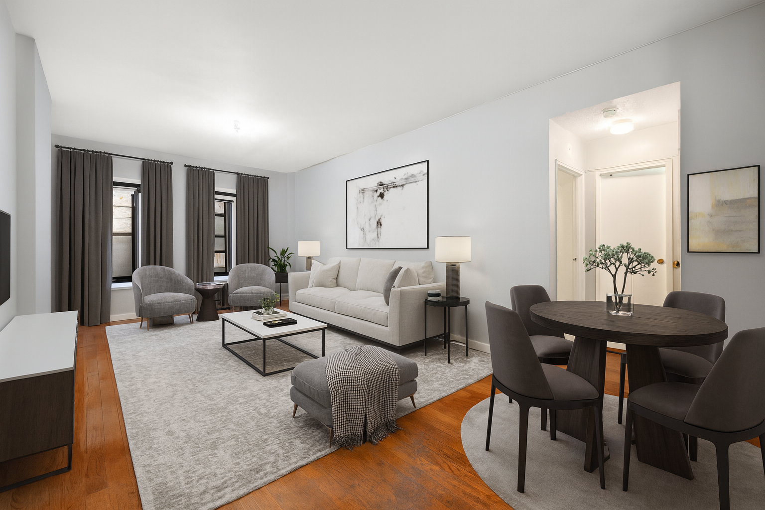 a living room with furniture potted plant and open kitchen view