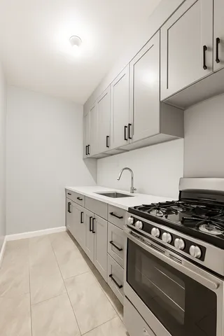 a kitchen with granite countertop a stove and a sink