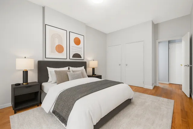 a bedroom with a bed and cabinets