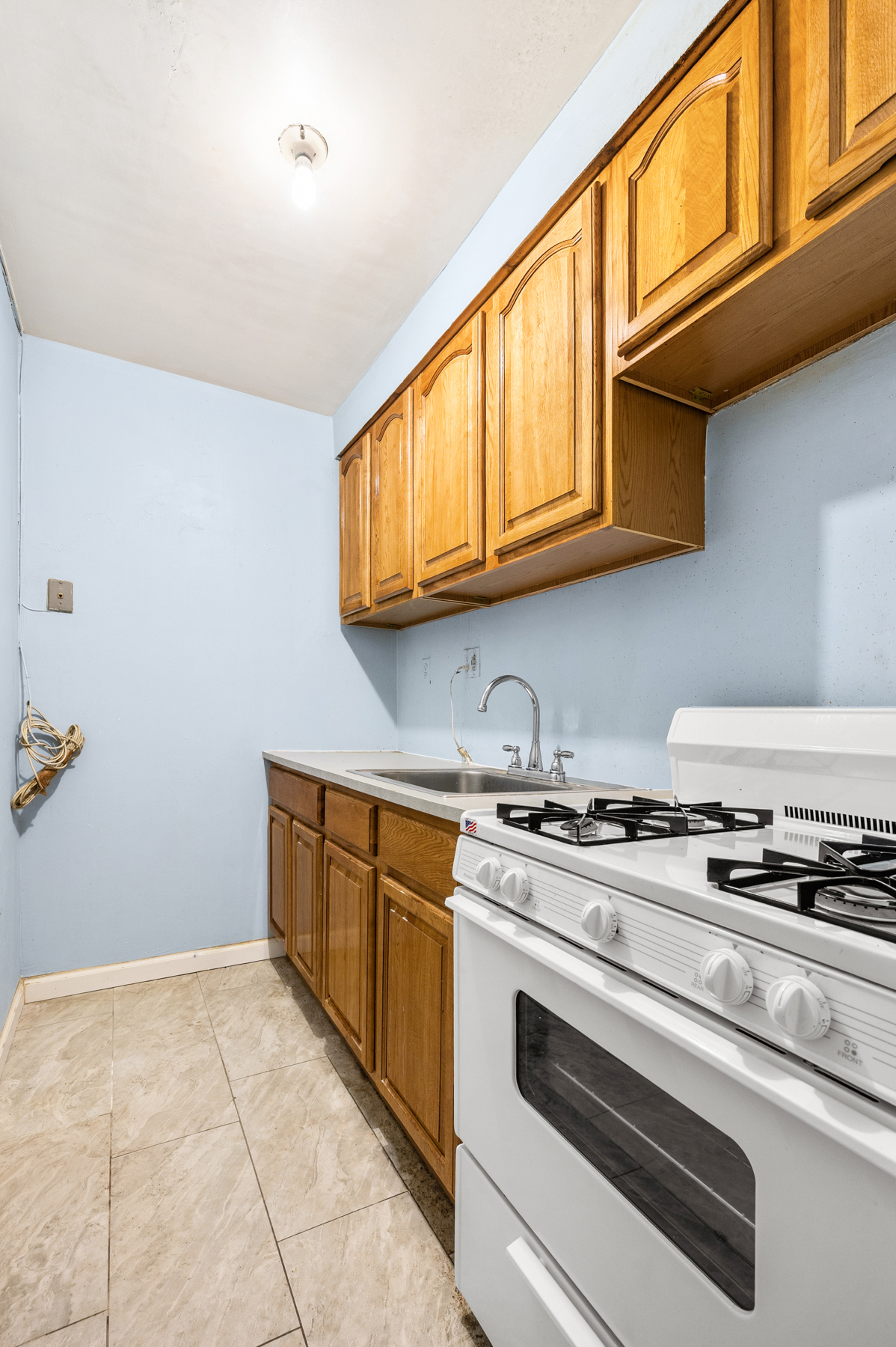 145-149 Morningside Avenue, Unit 1B Manhattan, NY 10027 - Photo 7 of 13 a kitchen with granite countertop a stove and a sink