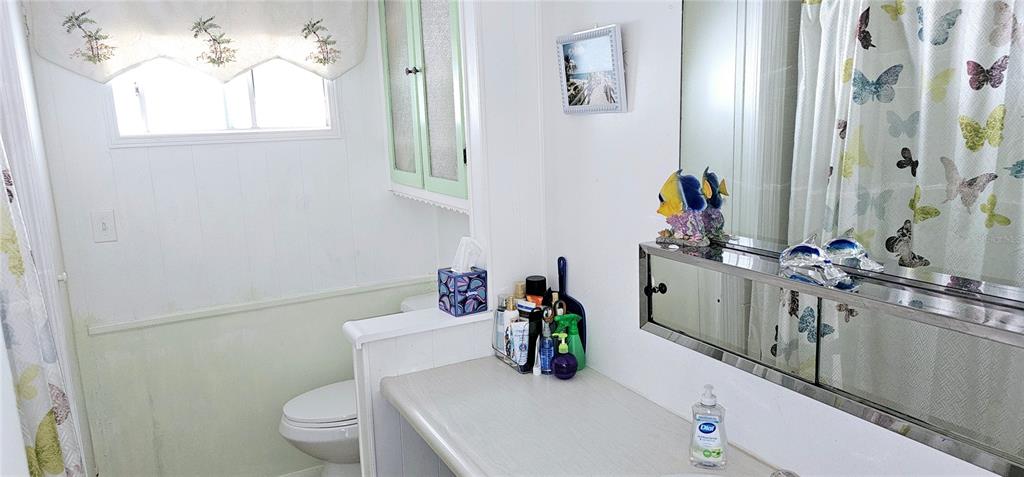 10315 Cortez Road West, Unit 281 Bradenton, FL 34210 - Photo 17 of 25 a bathroom with a sink mirror vanity and toilet