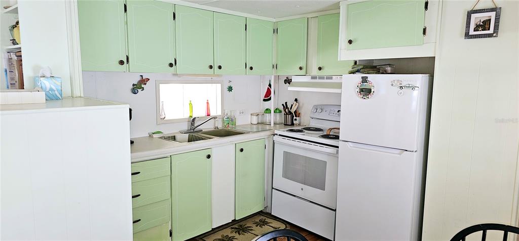 10315 Cortez Road West, Unit 281 Bradenton, FL 34210 - Photo 6 of 25 a kitchen with stainless steel appliances white cabinets and a refrigerator