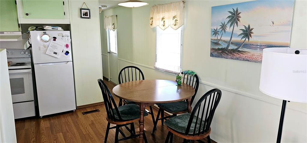 10315 Cortez Road West, Unit 281 Bradenton, FL 34210 - Photo 7 of 25 a view of a dining room with furniture and wooden floor
