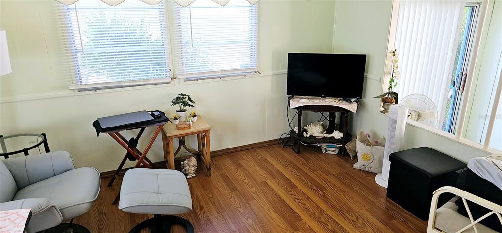 10315 Cortez Road West, Unit 281 Bradenton, FL 34210 - Photo 8 of 25 a living room with furniture and a flat screen tv