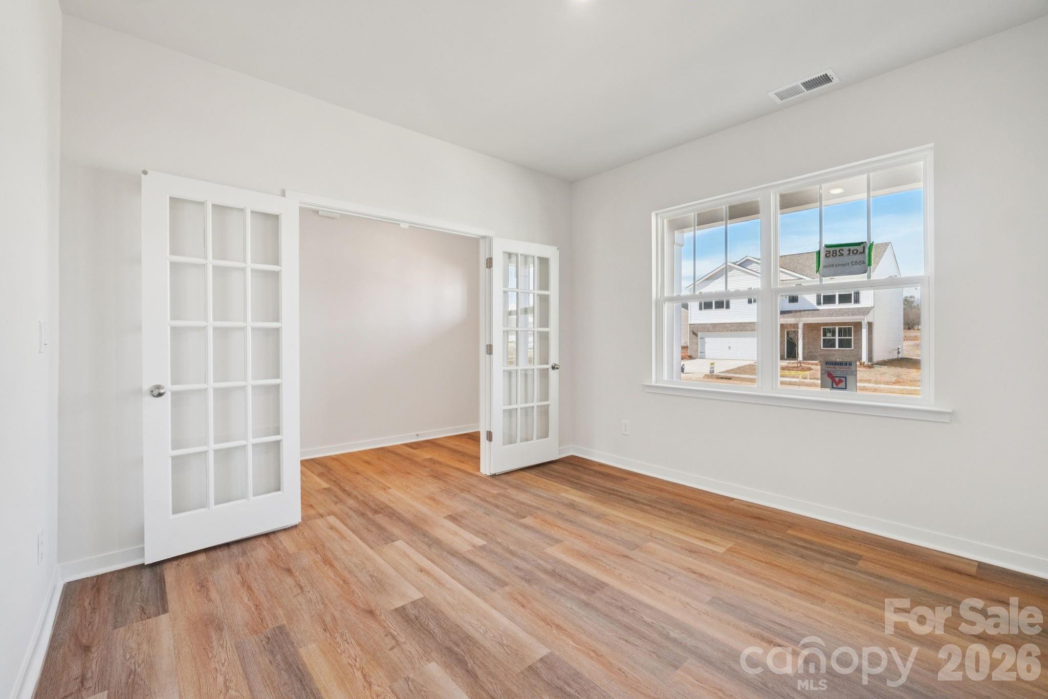 4559 Harris Elliot Road Lincolnton, NC 28092 - Photo 13 of 36 an empty room with wooden floor and windows