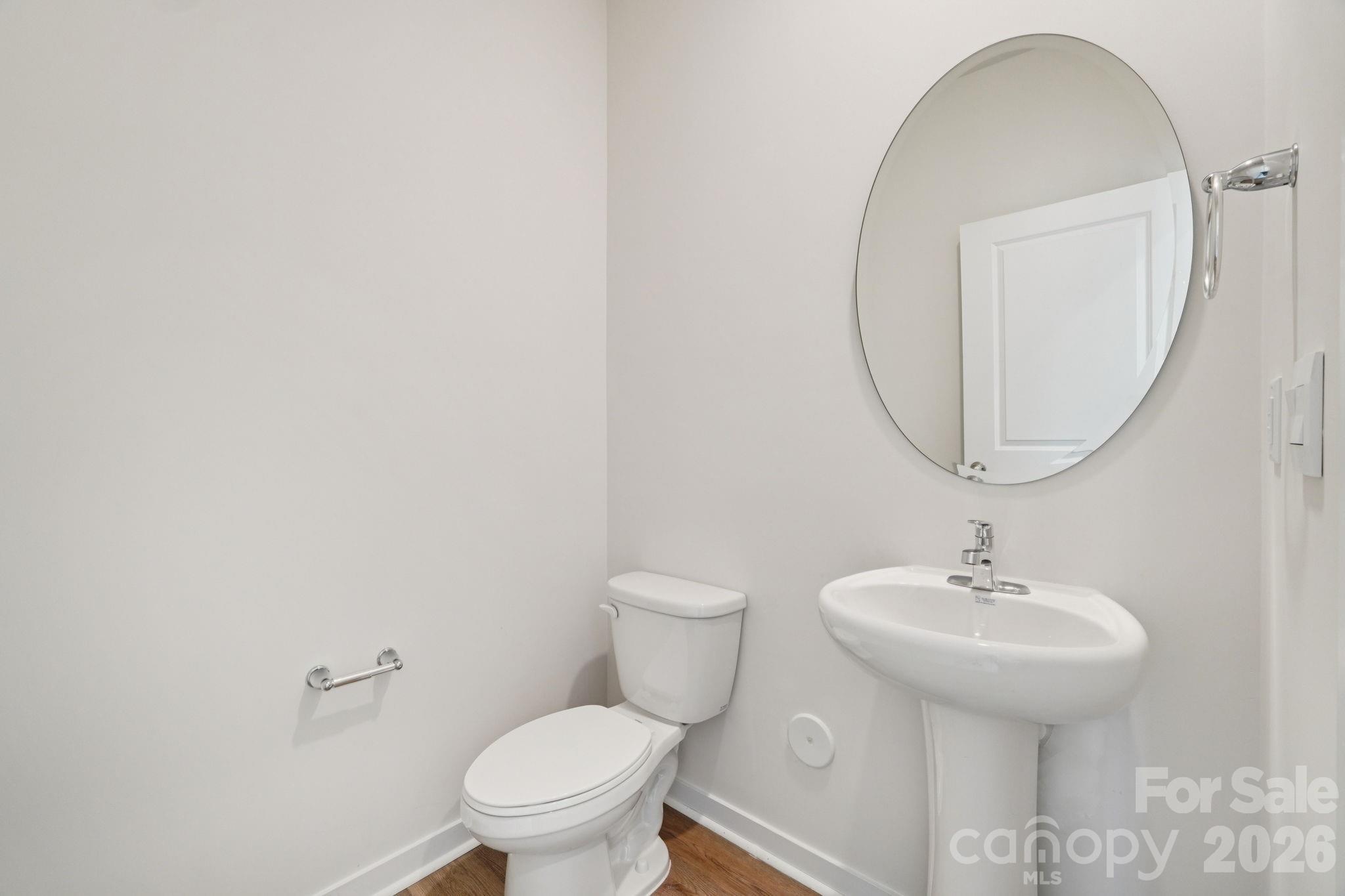 4559 Harris Elliot Road Lincolnton, NC 28092 - Photo 15 of 36 a bathroom with a toilet a sink and a mirror
