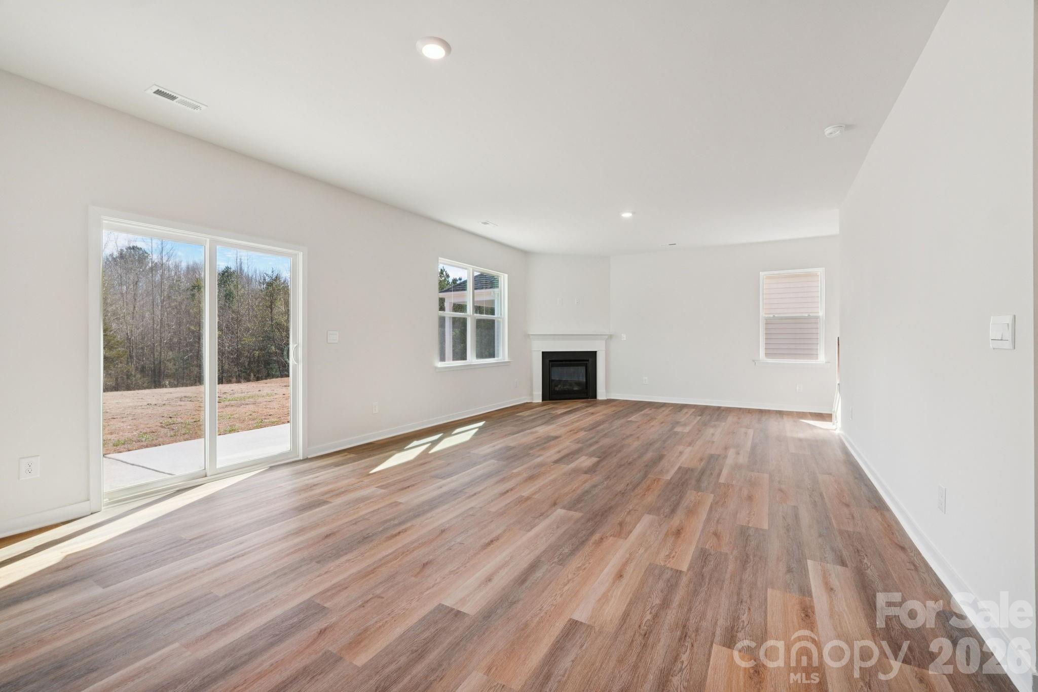 4559 Harris Elliot Road Lincolnton, NC 28092 - Photo 4 of 36 a view of empty room with wooden floor and fan