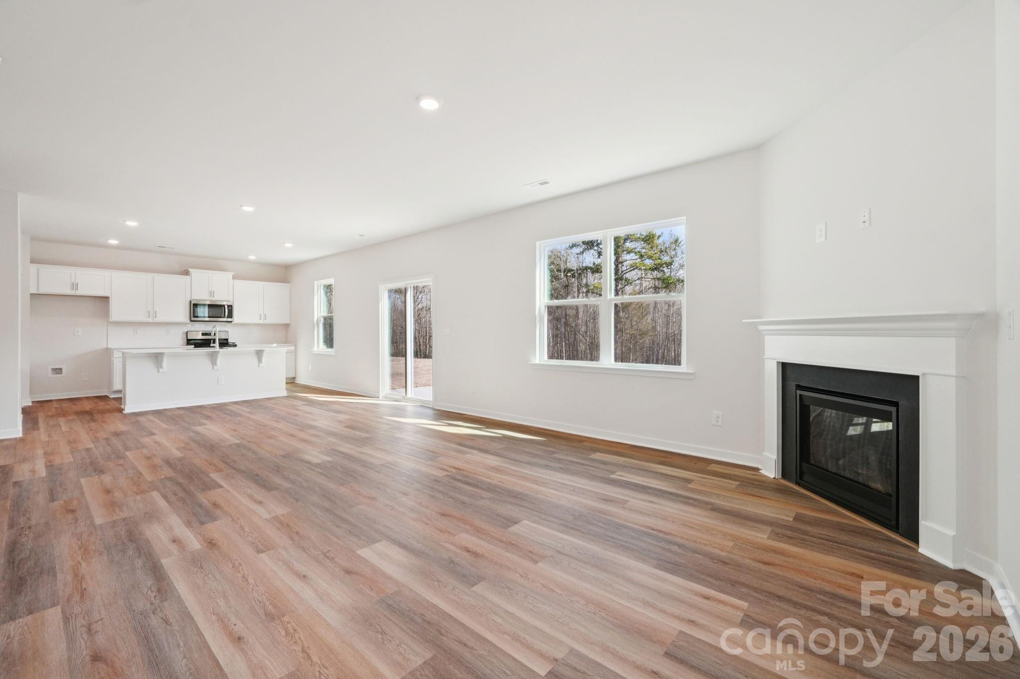 4559 Harris Elliot Road Lincolnton, NC 28092 - Photo 5 of 36 a view of empty room with wooden floor and fireplace