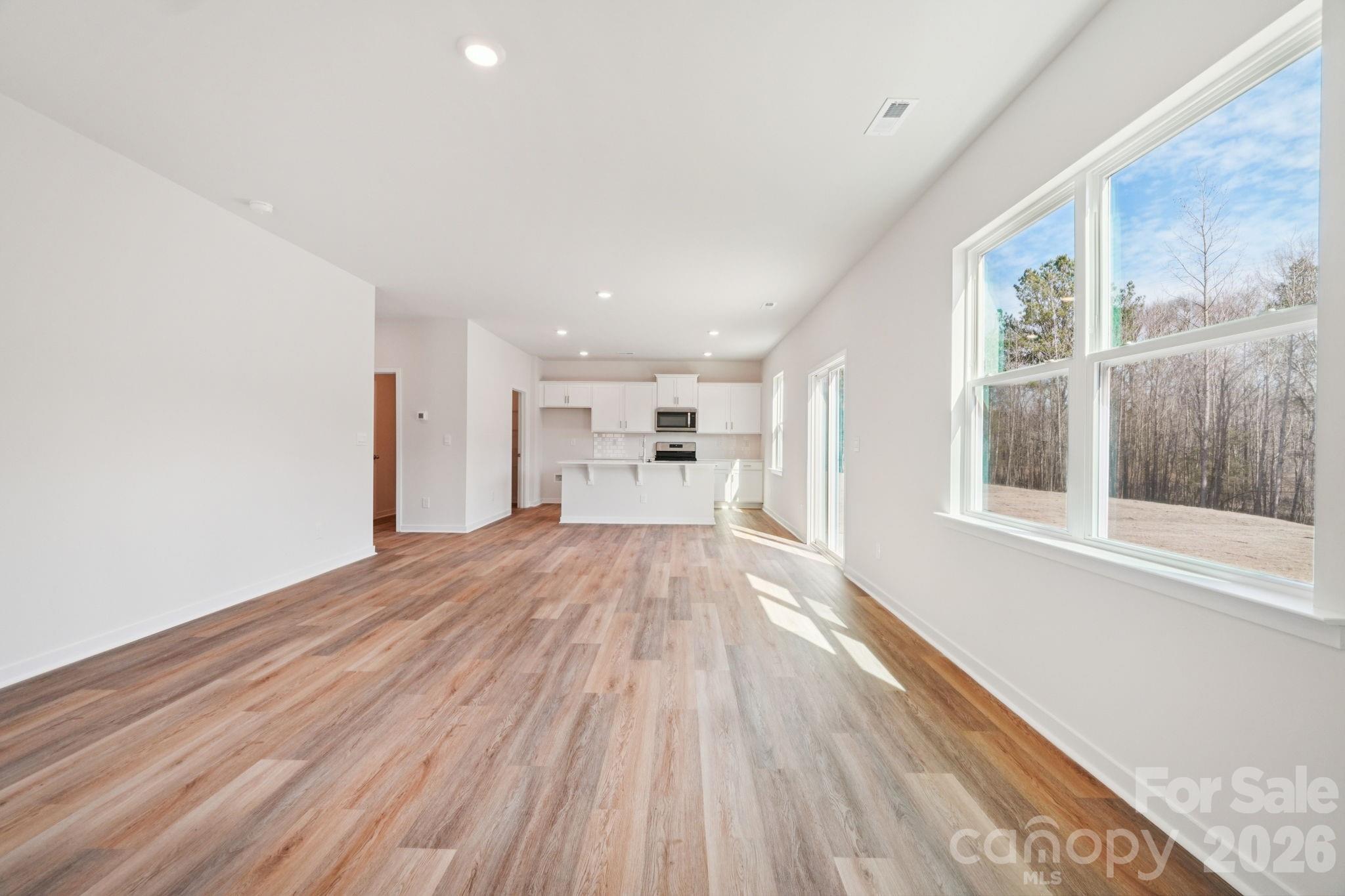 4559 Harris Elliot Road Lincolnton, NC 28092 - Photo 6 of 36 a view of empty room with wooden floor and windows