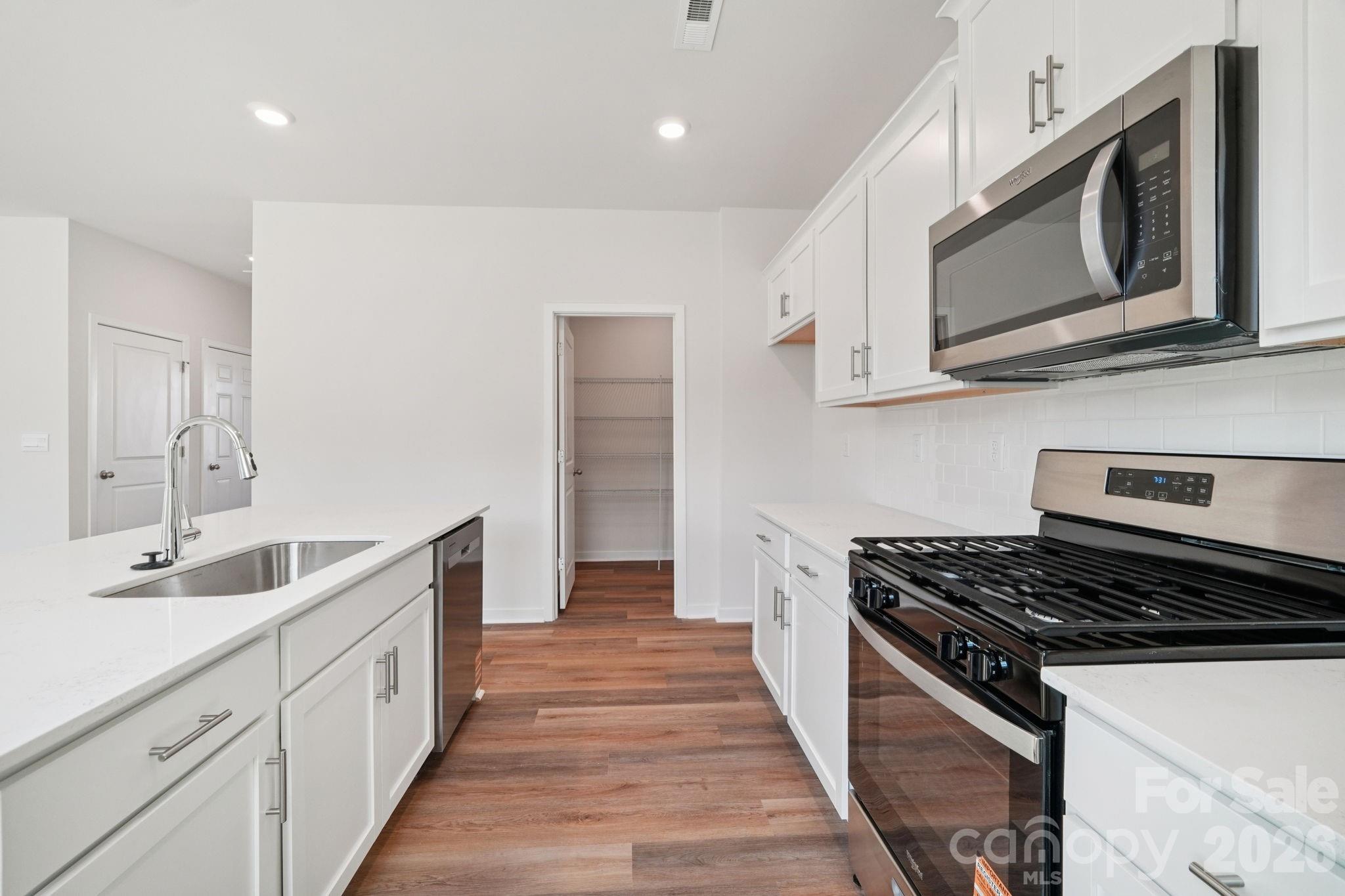4559 Harris Elliot Road Lincolnton, NC 28092 - Photo 8 of 36 a kitchen with stainless steel appliances granite countertop a stove and a microwave