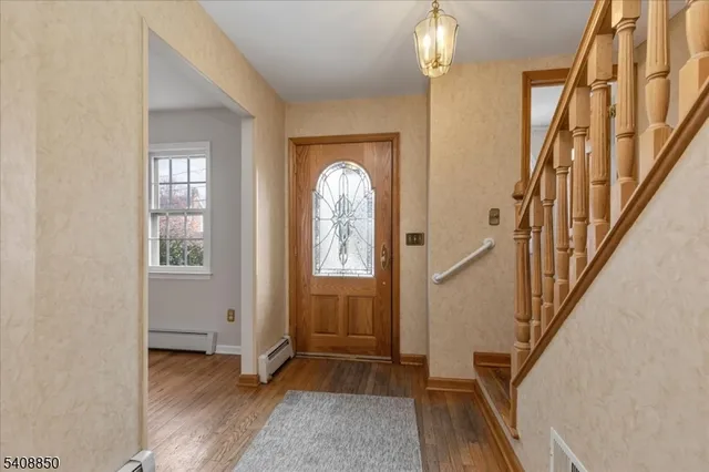 a view of an entryway with wooden floor
