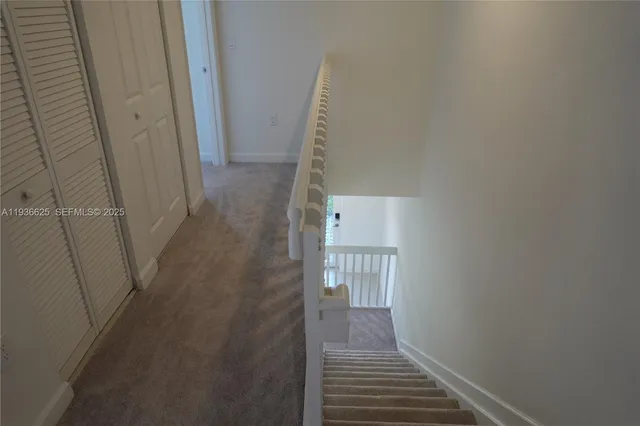 a view of a hallway with wooden floor and entryway