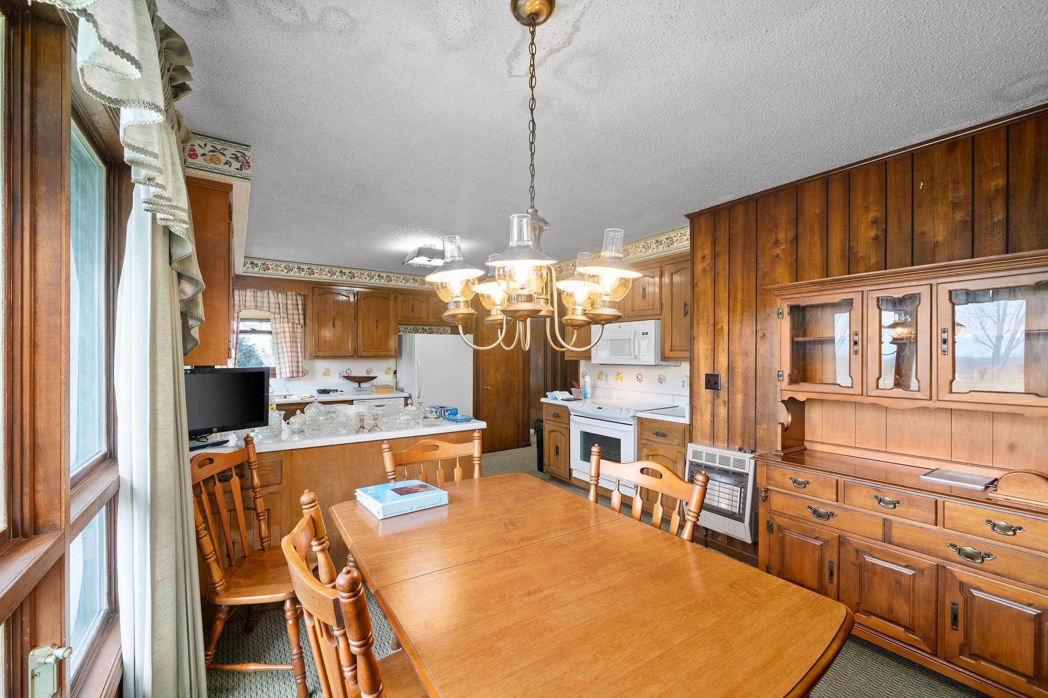 1075 Batson Mill Road Charlotte, TN 37036 - Photo 12 of 43 a dining room filled with furniture and a chandelier