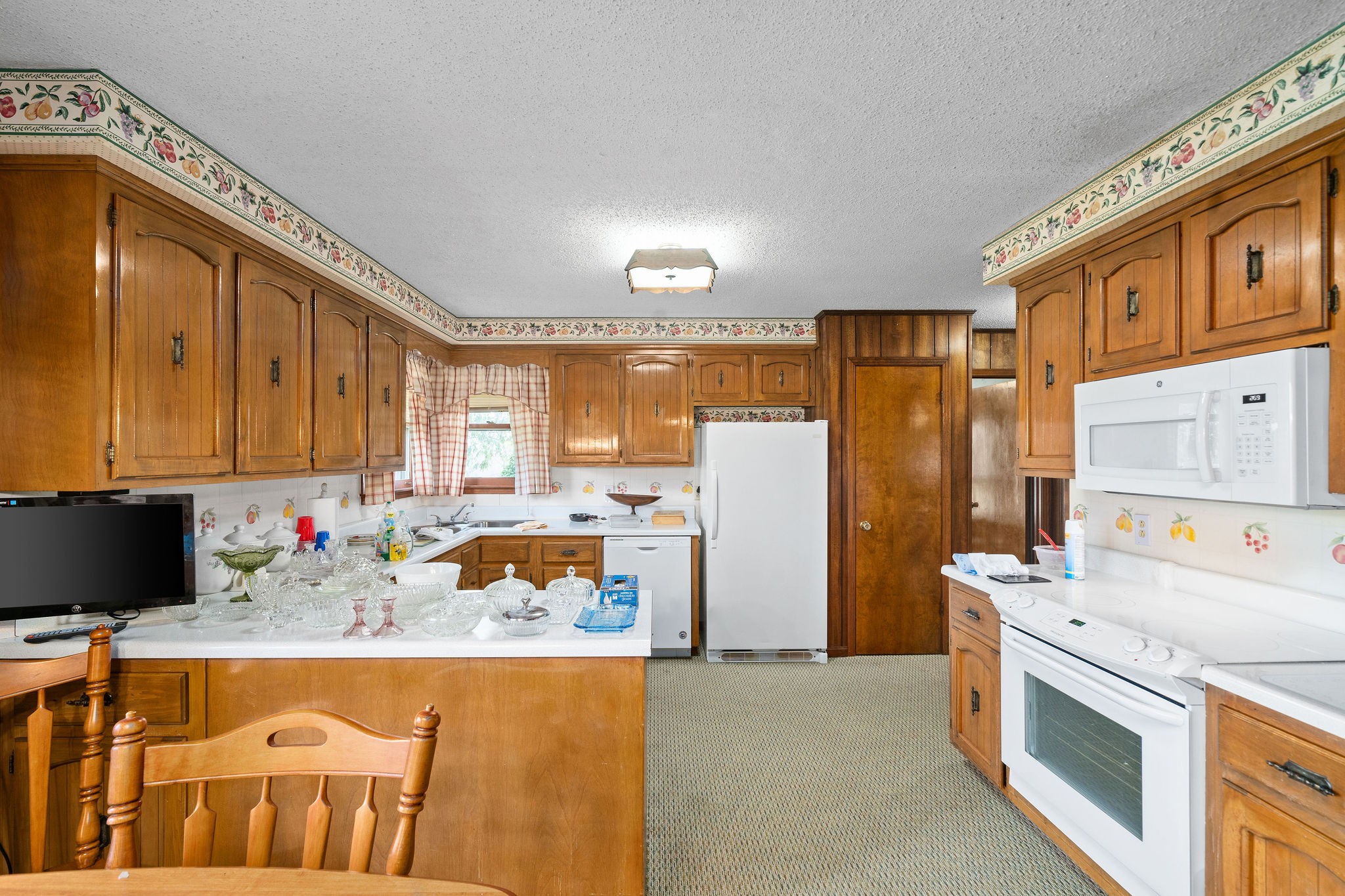 1075 Batson Mill Road Charlotte, TN 37036 - Photo 14 of 43 a kitchen with refrigerator and cabinets