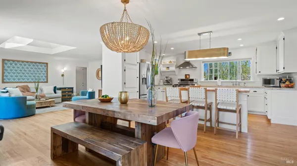 a kitchen with a dining table chairs stove and kitchen view