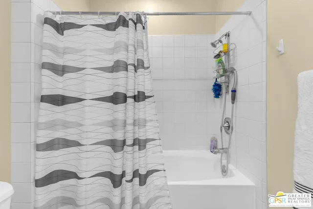 a bathroom with a bathtub and shower