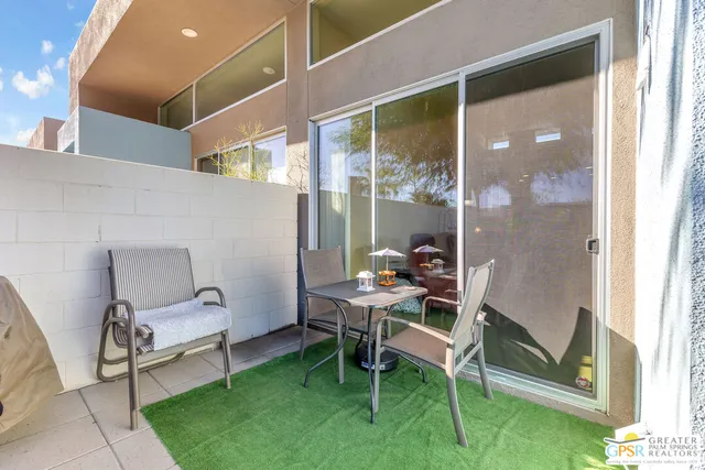 a balcony with table and chairs