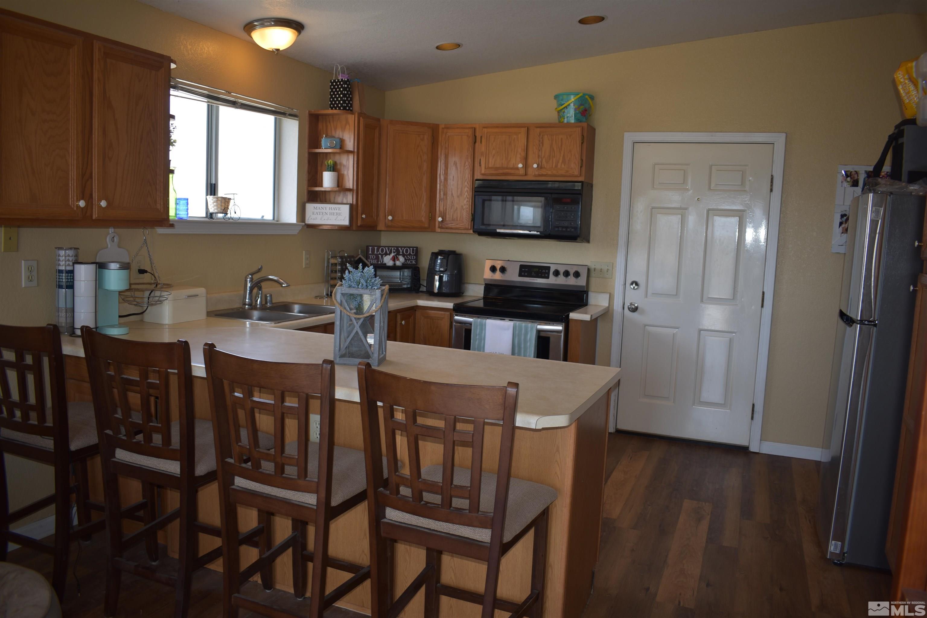 1737 Dee Jay Lane Minden, NV 89423 - Photo 16 of 40 a kitchen with stainless steel appliances a microwave sink and refrigerator